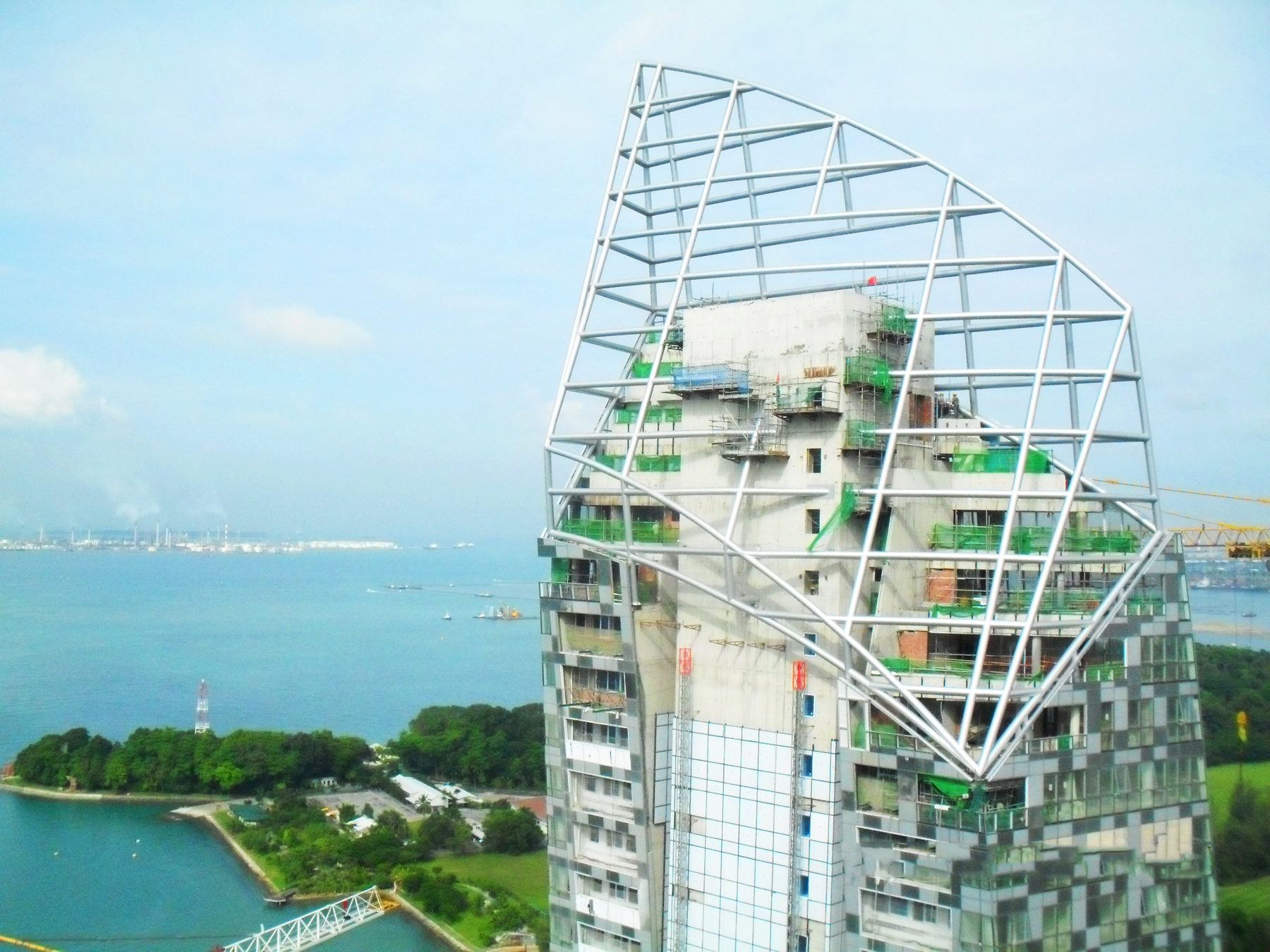 Architectural steel crown on top of a curved residential tower