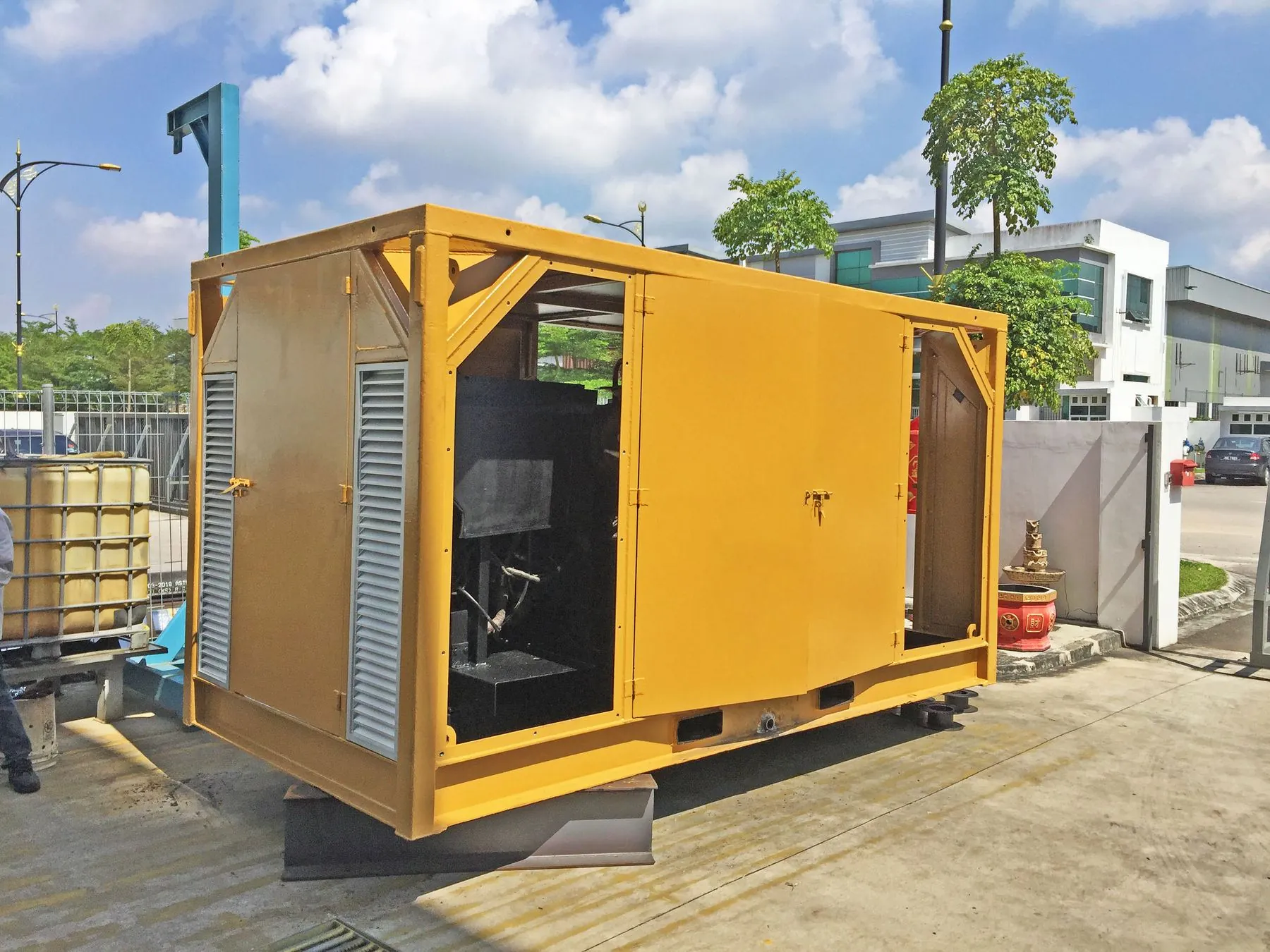 Completed offshore machine frame with bolted box cover, painted yellow